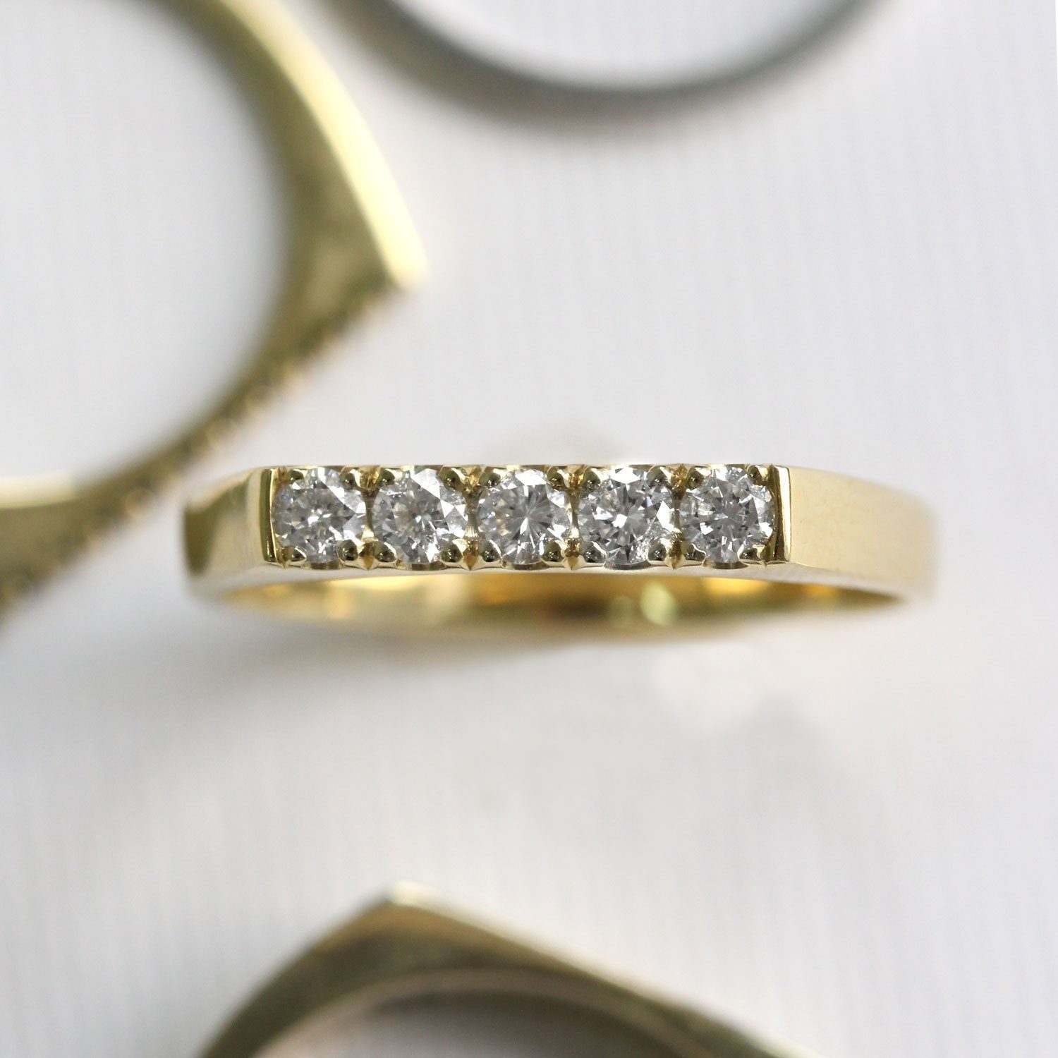 gold ring with flat top and 5 diamonds