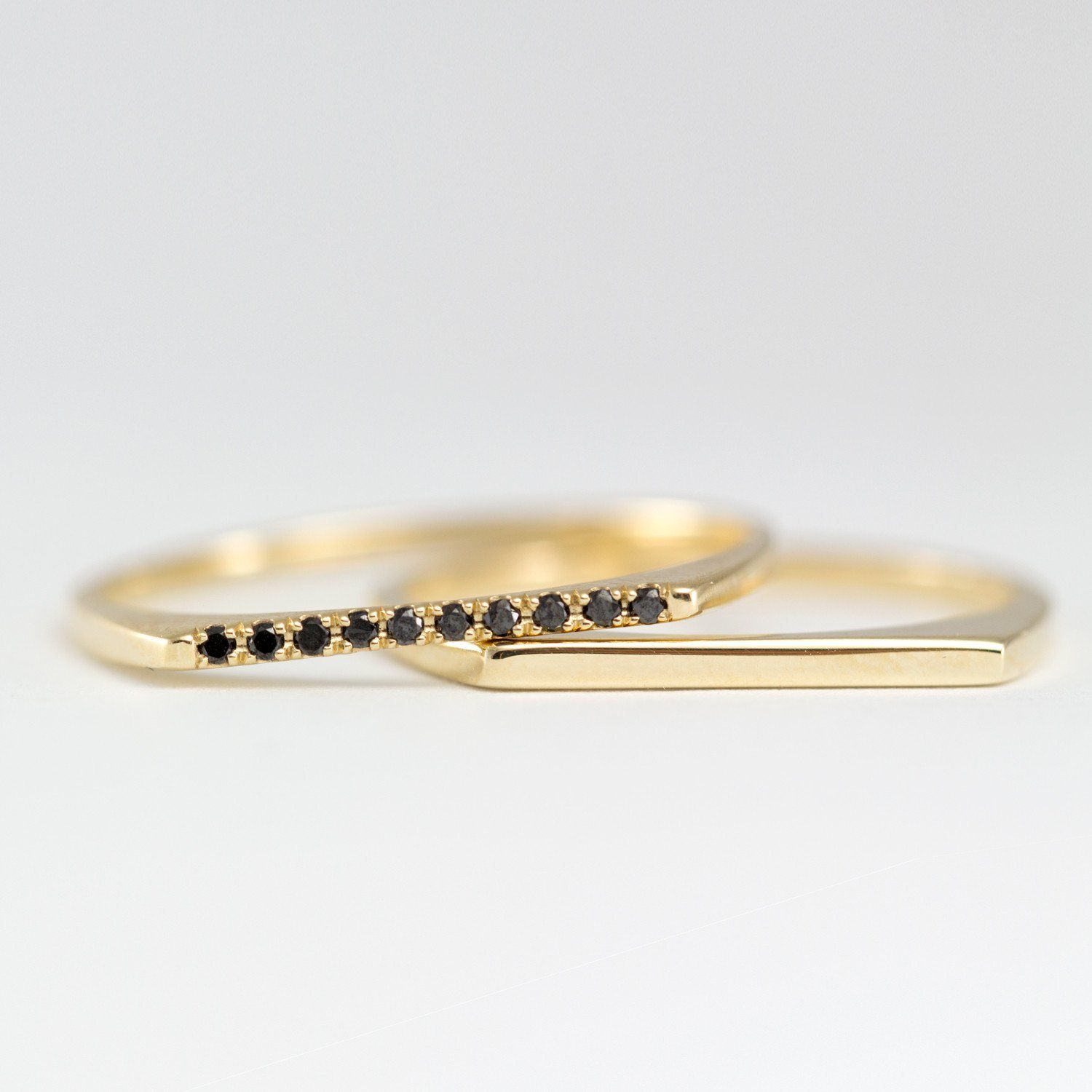 thin gold ring with 10 black diamonds